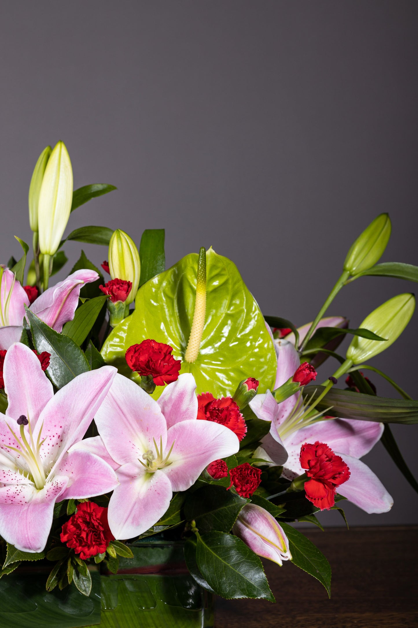 Charming Pinks - Elegant long and low centerpiece with aromatic Oriental Lilies, Spray Carnation, and Eustoma flowers in a glass container | Flower delivery in Bengaluru | Buy flower bouquets online Bengaluru | Same-day flower delivery Bengaluru | Online florist Bengaluru | Order flowers online Bengaluru | Luxury flower bouquet in Bengaluru