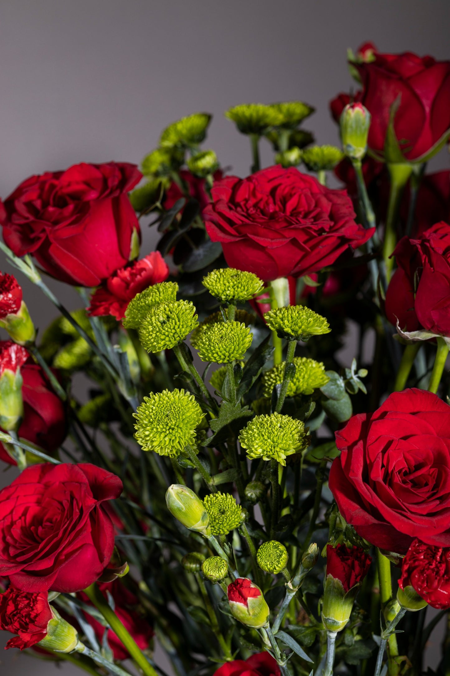 RED HAZE – Stunning red roses, red carnation sprays, and green chrysanthemum stems in a pickle jar – Flower delivery in Bengaluru, Buy flower bouquets online Bengaluru, Same-day flower delivery Bengaluru, Online florist Bengaluru, Order flowers online Bengaluru, Luxury flower bouquet in Bengaluru