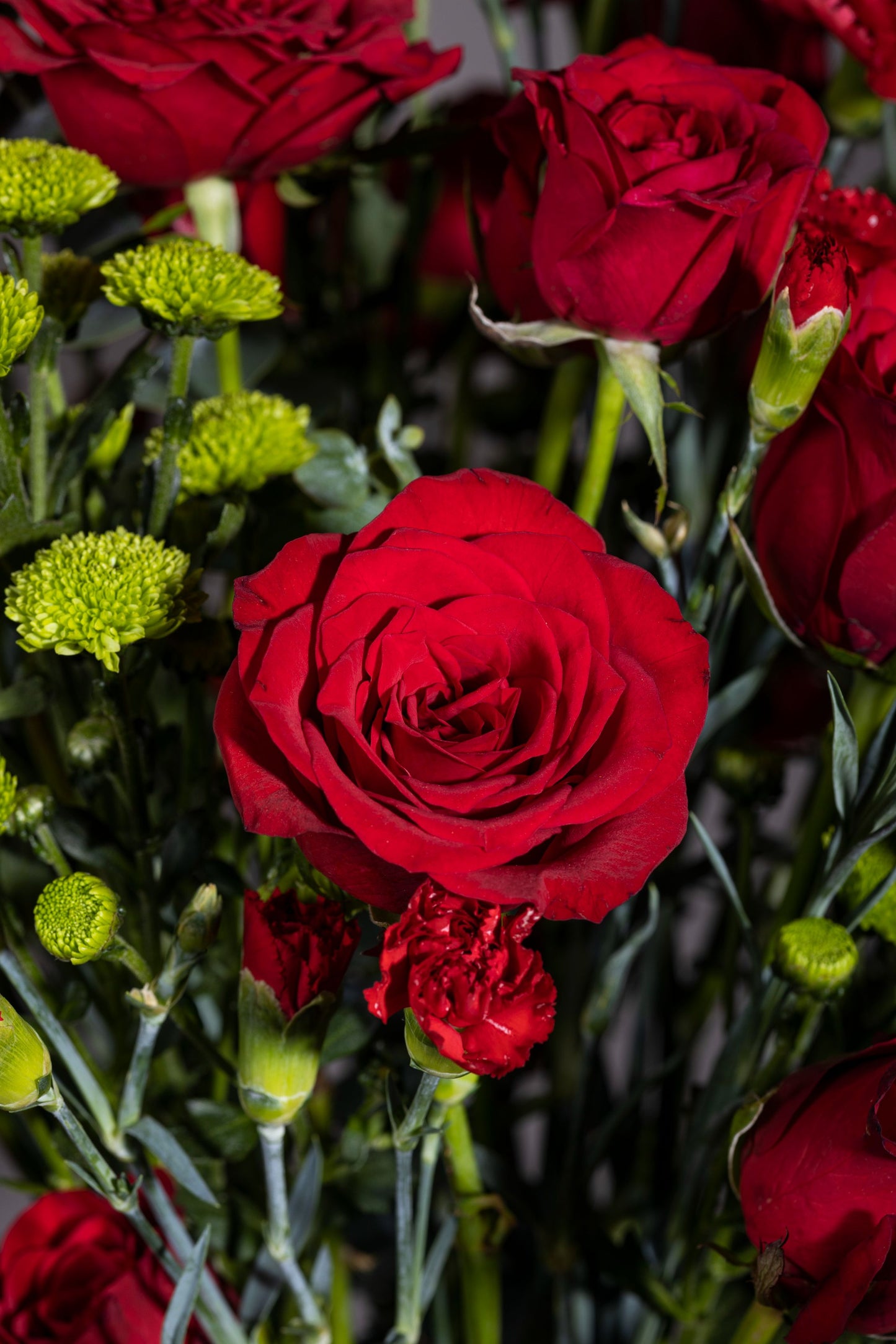 RED HAZE – Stunning red roses, red carnation sprays, and green chrysanthemum stems in a pickle jar – Flower delivery in Bengaluru, Buy flower bouquets online Bengaluru, Same-day flower delivery Bengaluru, Online florist Bengaluru, Order flowers online Bengaluru, Luxury flower bouquet in Bengaluru