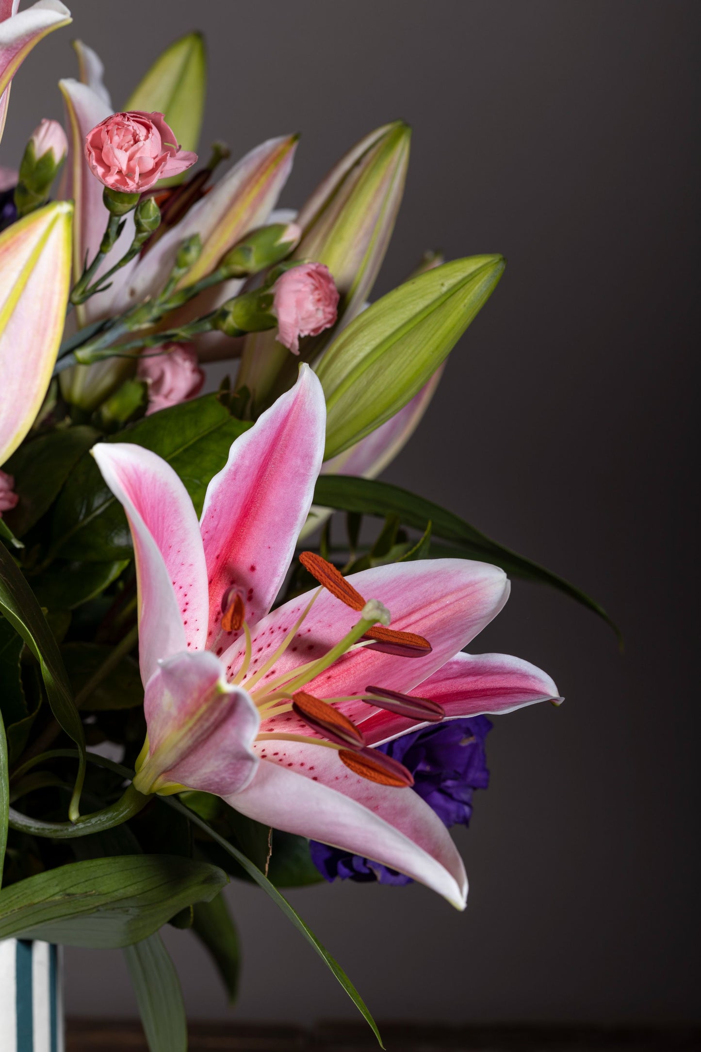 Romantic – A stunning custom keepsake hat box filled with fragrant Pink Oriental Lilies and elegant Purple Lisianthus blooms, complemented by lush foliage. The perfect gift for birthdays, anniversaries, thank you gestures, congratulations, and new baby celebrations