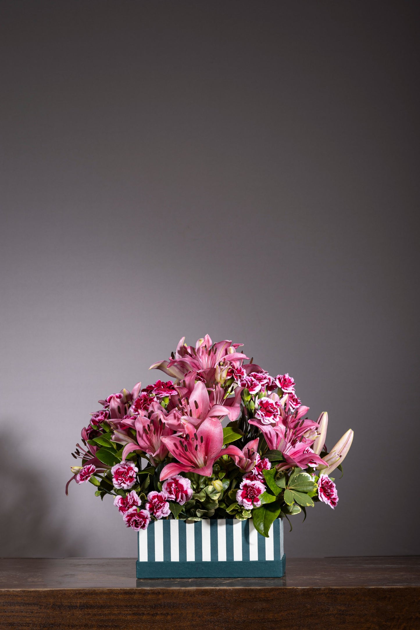 Luxury Magenta Lily and Spray Carnation flower bouquet in a signature keepsake box. Perfect for birthdays, anniversaries, thank you gifts, congratulations, and new baby celebrations. 🌸 Same-day flower delivery in Bengaluru. Order flowers online from the best florist in Bengaluru