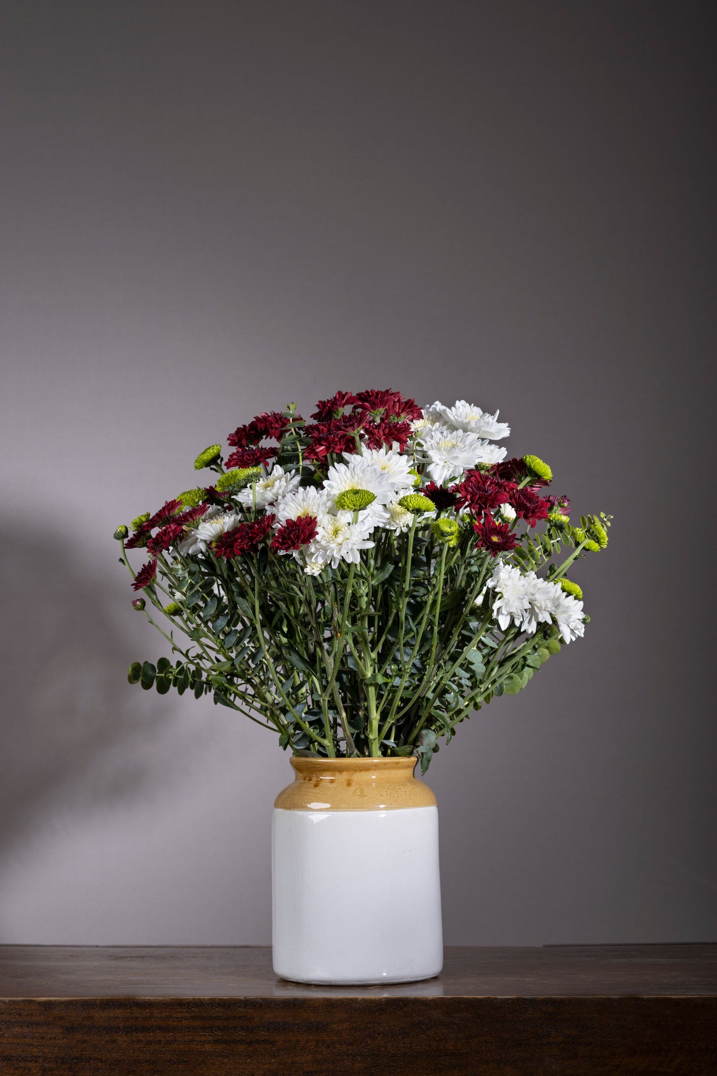 Ruddy Glow - A glowing pickle jar with Red and White Chrysanthemum flowers and fresh Silver Dollar Eucalyptus stems | Flower delivery in Bengaluru, Buy flower bouquets online in Bengaluru, Same-day flower delivery Bengaluru, Online florist Bengaluru, Order flowers online Bengaluru, Luxury flower bouquet in Bengaluru