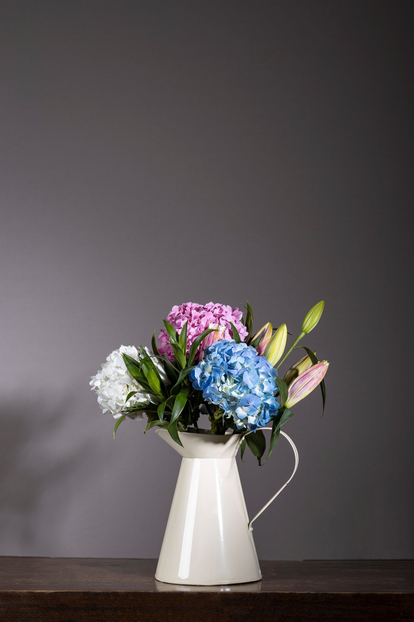 PURE AND SIMPLE bouquet with mixed colour Hydrangea bunches and Pink Oriental Lilies in a powder-coated tin – Flower delivery in Bengaluru, Buy flower bouquets online in Bengaluru, Same-day flower delivery Bengaluru, Online florist Bengaluru, Order flowers online Bengaluru, Luxury flower bouquet in Bengaluru