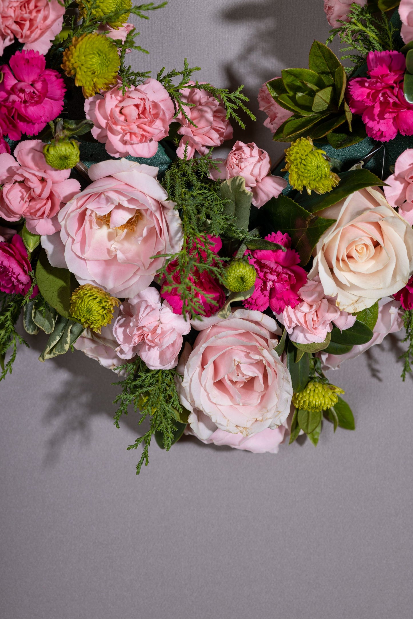 Heartfelt – A stunning heart-shaped wreath adorned with delicate pastel blossoms, set against a lush green foliage base. A perfect gift for birthdays, anniversaries, thank you gestures, congratulations, and welcoming a new baby
