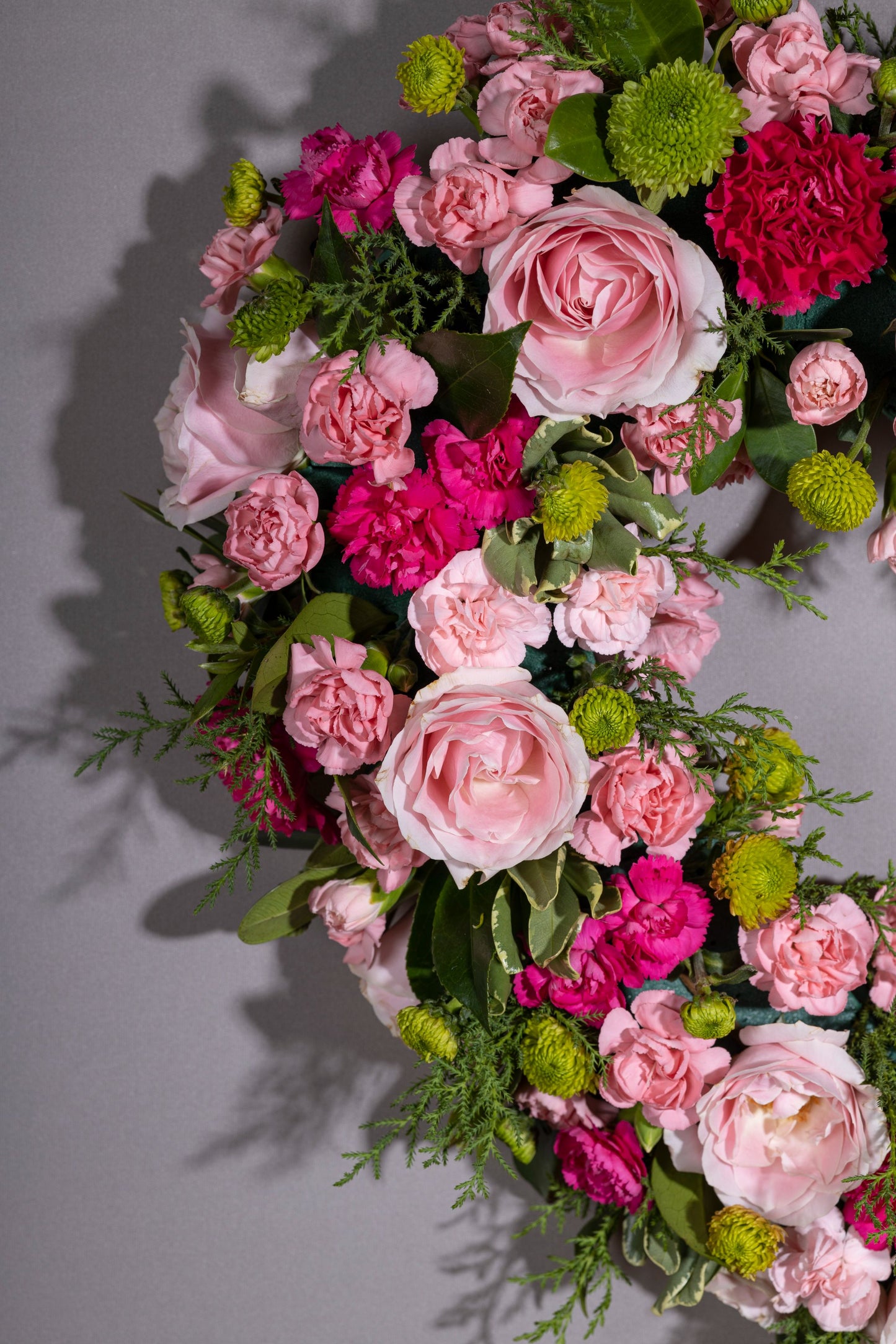 Heartfelt – A stunning heart-shaped wreath adorned with delicate pastel blossoms, set against a lush green foliage base. A perfect gift for birthdays, anniversaries, thank you gestures, congratulations, and welcoming a new baby