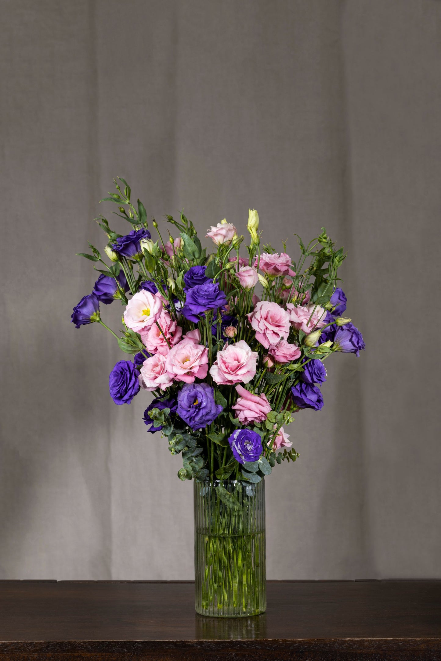 DIVINE EUSTOMA - A divine and uplifting floral arrangement of enduring Pink and Purple Lisianthus flowers in a tall glass vase. Perfect for Birthdays, Anniversaries, Thank You, Congratulations, New Baby, and Condolence. Flower delivery in Bengaluru, Buy flower bouquets online Bengaluru, Same-day flower delivery Bengaluru, Online florist Bengaluru, Order flowers online Bengaluru, Luxury flower bouquet in Bengaluru