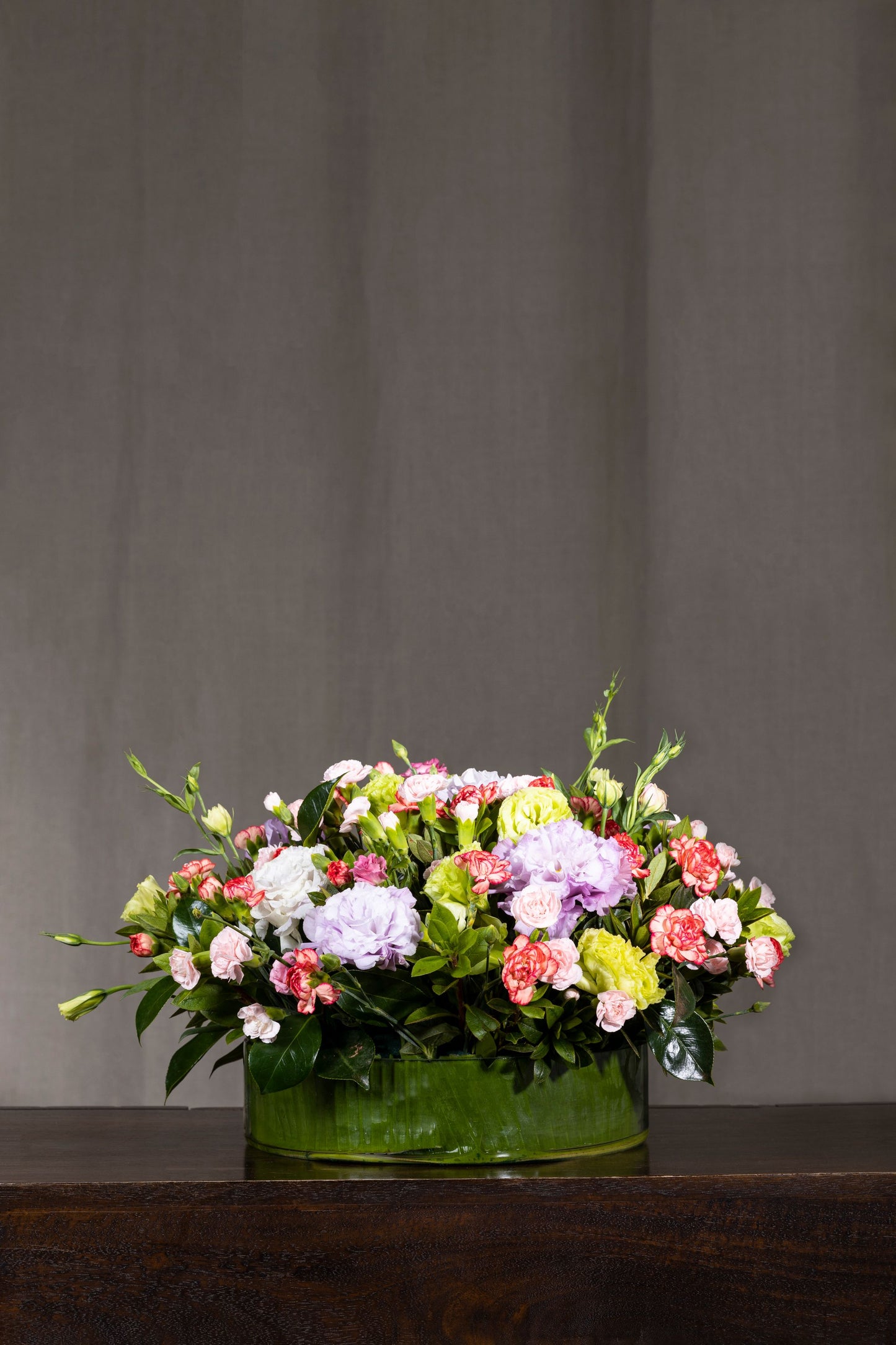 JOY OF BEAUTY - A timeless floral arrangement featuring mixed-color Lisianthus flowers and Spray Carnations in a round glass container. Perfect for Birthdays, Anniversaries, Thank You, Congratulations, New Baby, and Condolence. Flower delivery in Bengaluru, Buy flower bouquets online Bengaluru, Same-day flower delivery Bengaluru, Online florist Bengaluru, Order flowers online Bengaluru, Luxury flower bouquet in Bengaluru