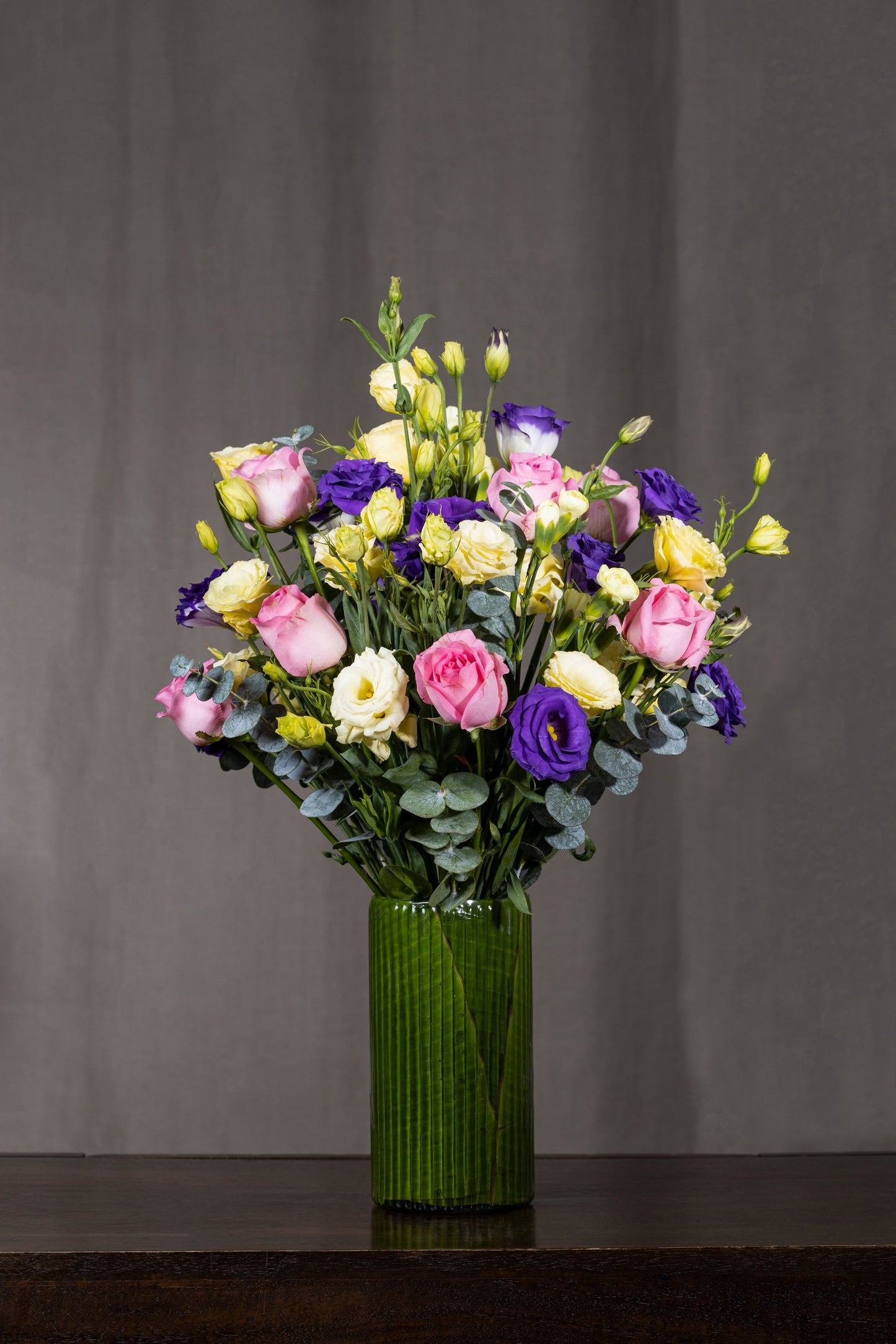 PASTEL BEAUTY - A sleek tall glass vase elegantly arranged with mixed-color Lisianthus blooms and premium roses. Perfect for Birthdays, Anniversaries, Thank You, Congratulations, New Baby, and Condolence. Flower delivery in Bengaluru, Buy flower bouquets online Bengaluru, Same-day flower delivery Bengaluru, Online florist Bengaluru, Order flowers online Bengaluru, Luxury flower bouquet in Bengaluru