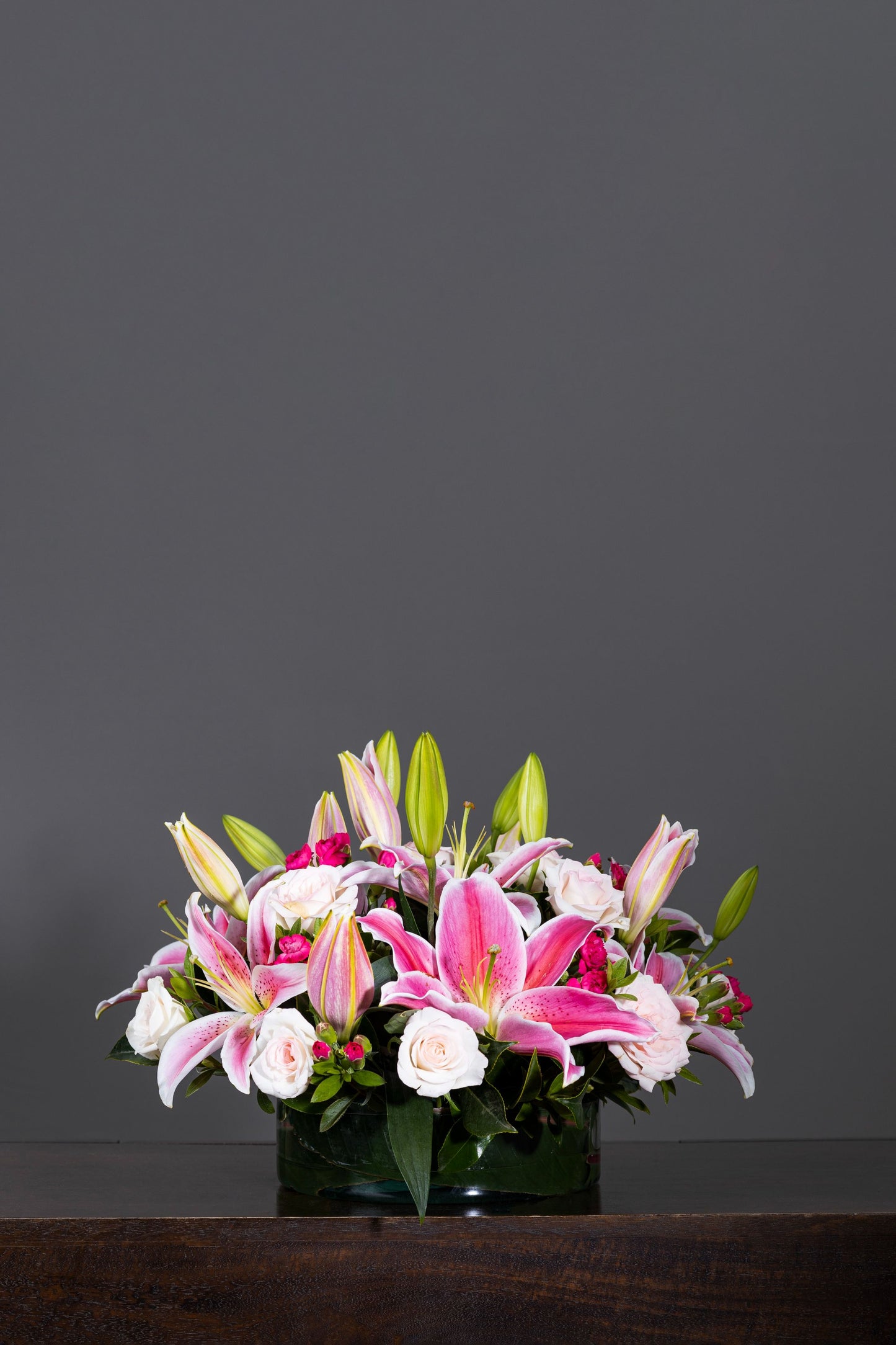 PERFUMERY - A delightful floral arrangement featuring aromatic pink Oriental Lilies complemented by White Carnation blossoms in an elegant glass container. Perfect for Birthdays, Anniversaries, Thank You, Congratulations, New Baby, and Condolence. Flower delivery in Bengaluru, Buy flower bouquets online in Bengaluru, Same-day flower delivery Bengaluru, Online florist Bengaluru, Order flowers online Bengaluru, Luxury flower bouquet in Bengaluru