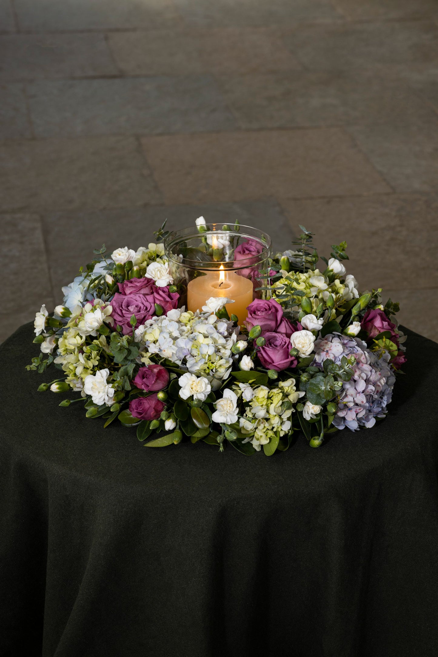 CIRCLE OF LIFE - A stunning floral wreath adorned with Hydrangea bunches, Roses, and a central candle, creating an elegant circle of life theme for any special dinner. Perfect for Birthdays, Anniversaries, Thank You, Congratulations, New Baby, and Condolence. Flower delivery in Bengaluru, Buy flower bouquets online in Bengaluru, Same-day flower delivery Bengaluru, Online florist Bengaluru, Order flowers online Bengaluru, Luxury flower bouquet in Bengaluru