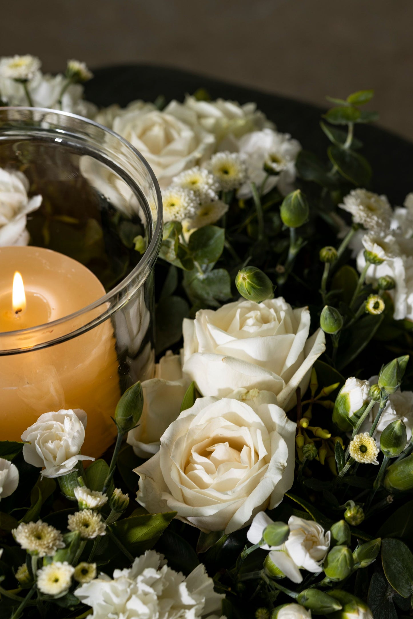 CIRCLE OF SIMPLICITY - A serene and elegant wreath of white flowers, including Carnations, Chrysanthemums, and seasonal favorites, accompanied by a candle for a peaceful touch. Perfect for Birthdays, Anniversaries, Thank You, Congratulations, New Baby, and Condolence. Flower delivery in Bengaluru, Buy flower bouquets online in Bengaluru, Same-day flower delivery Bengaluru, Online florist Bengaluru, Order flowers online Bengaluru, Luxury flower bouquet in Bengaluru