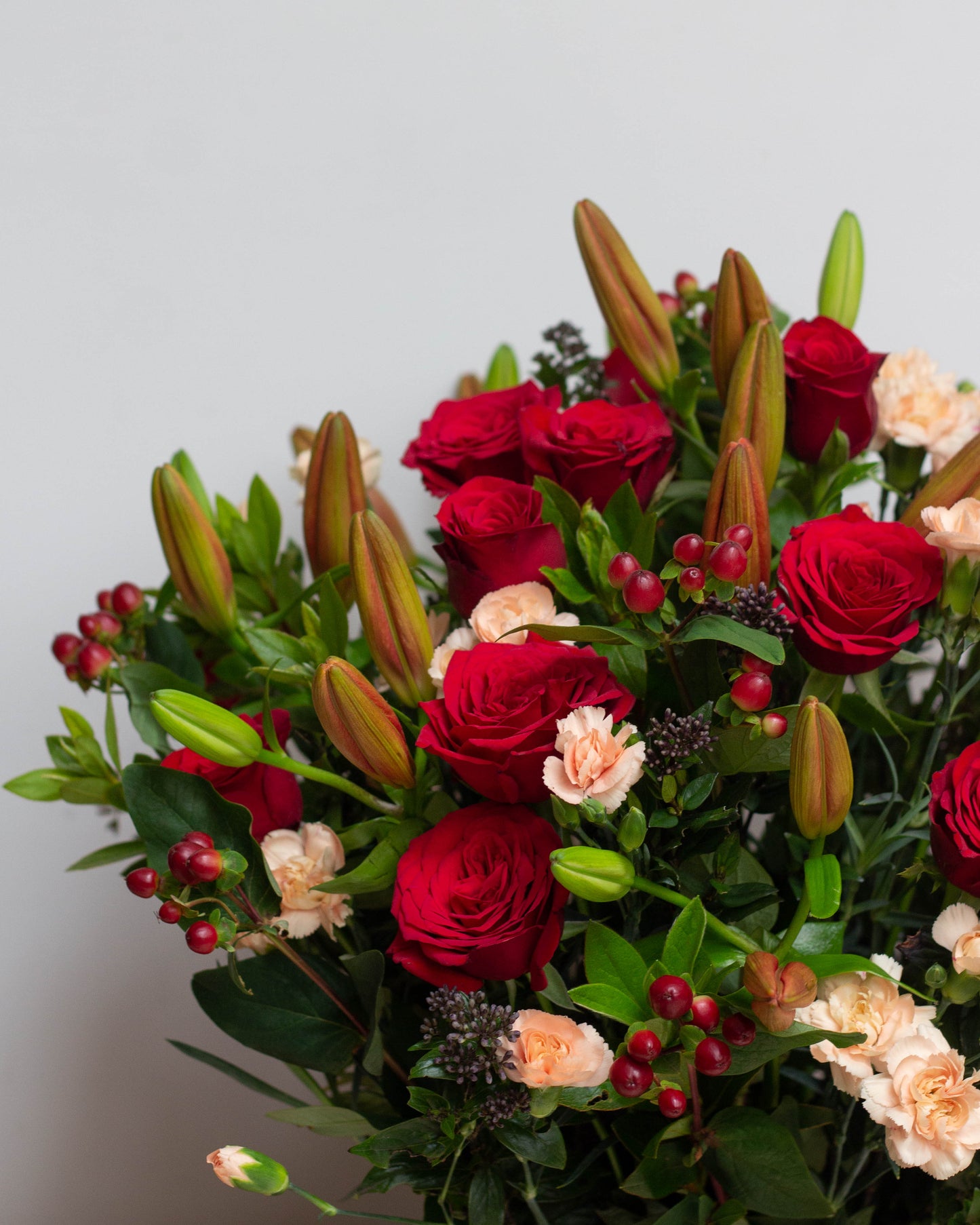 I AM ON FIRE – A passionate floral arrangement featuring deep Red Lilies, bright Red Roses, Peach Spray Carnations, and Red Hypericum berries in a beautiful square tin. Perfect for Valentine’s Day, birthdays, anniversaries, congratulations, new baby celebrations, and thank you gifts. Flower delivery in Bengaluru | Buy flower bouquets online Bengaluru | Same-day flower delivery Bengaluru | Online florist Bengaluru | Order flowers online Bengaluru | Luxury flower bouquet in Bengaluru
