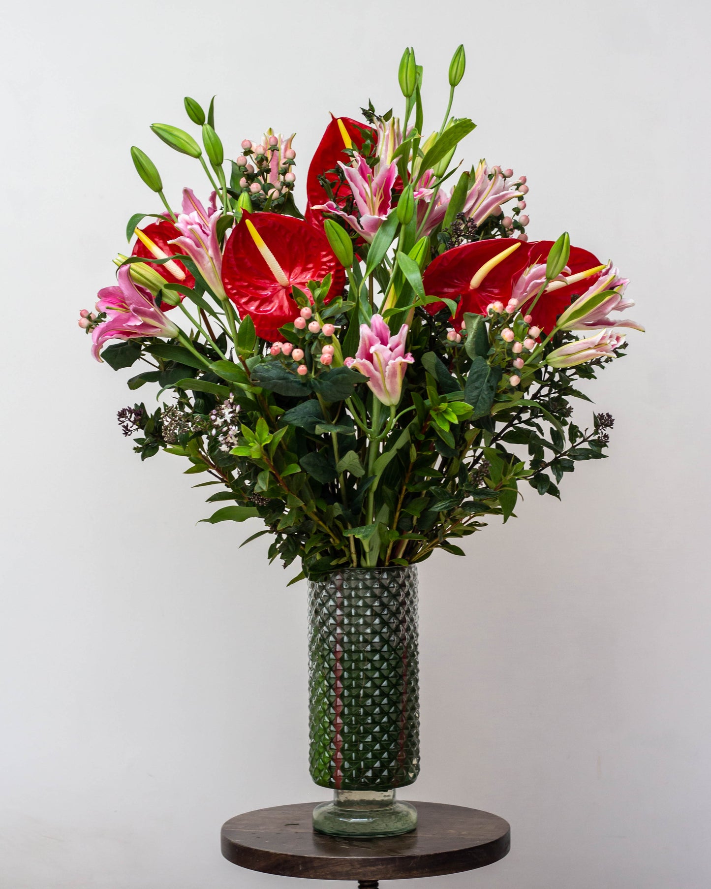My Heart Will Go On – A stunning glass container with intricate details, symbolizing everlasting love. Featuring vibrant Red Anthurium, Pink Oriental Lilies, delicate Pink Berries, and lush green fillers, perfect for Valentine’s Day, birthdays, anniversaries, congratulations, new baby celebrations, and thank you gifts. Flower delivery in Bengaluru | Buy flower bouquets online Bengaluru | Same-day flower delivery Bengaluru | Online florist Bengaluru | Order flowers online Bengaluru
