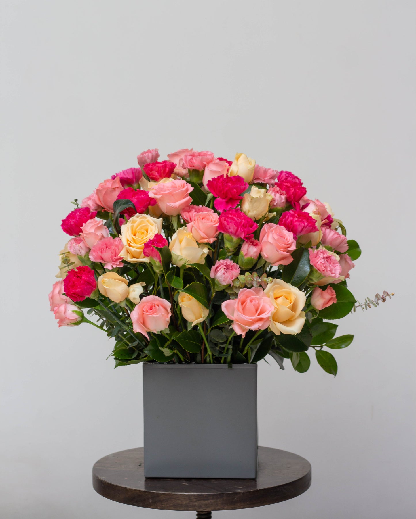 We Belong Together – A stunning bouquet of pink, peach, and light pink carnations with dark pink accents in a custom colorful tin. Perfect for same-day flower delivery in Bangalore, online flower delivery, and premium bouquet delivery for birthdays, anniversaries, and special occasions.