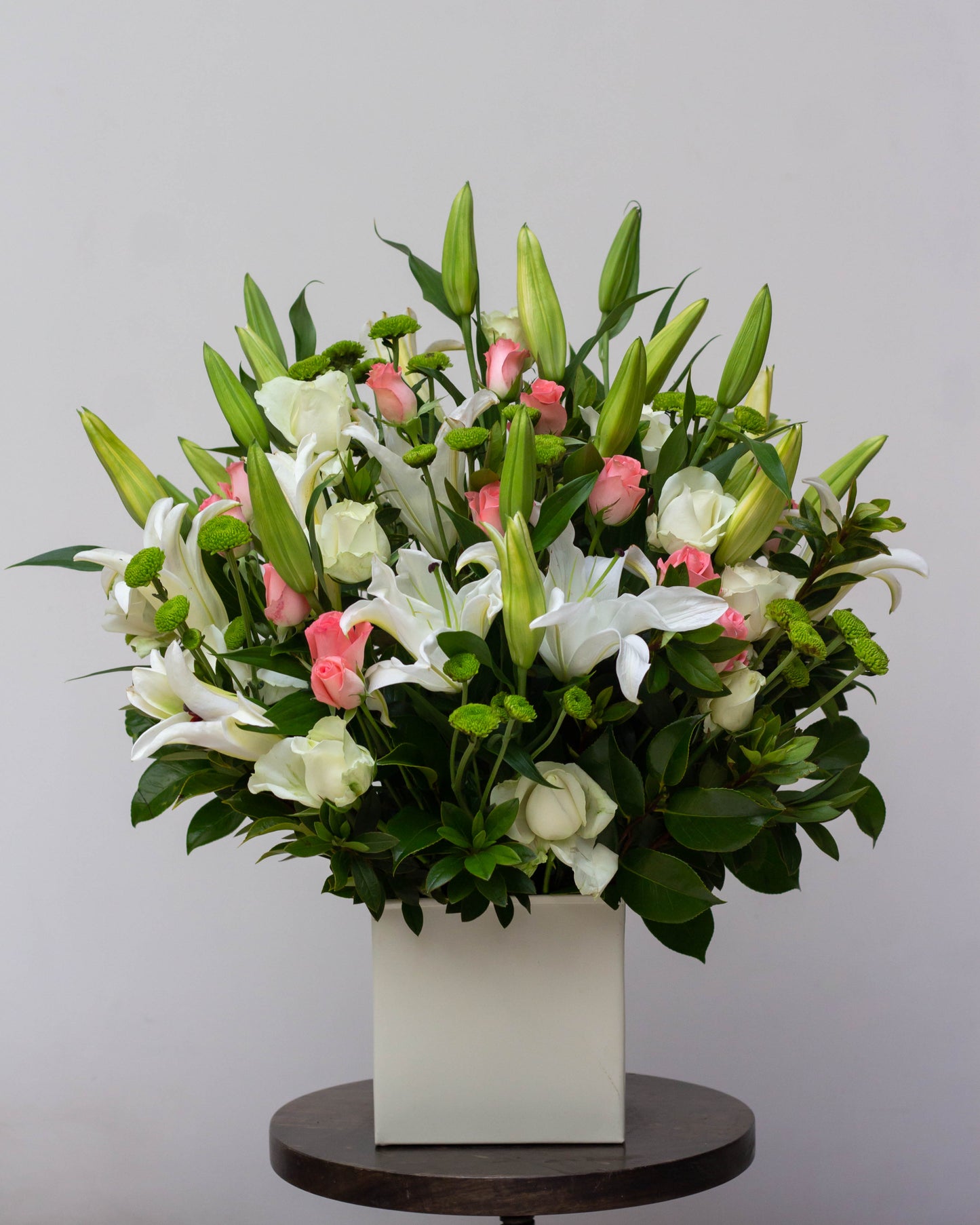 Premium flower delivery featuring an elegant white tin with White Oriental Lilies, soft Pink Roses, and fresh Green Chrysanthemum blooms. This big flower bouquet is perfect for same-day florist delivery, online flower delivery in Bangalore, and bouquet delivery near you. Ideal for special occasions like birthdays, anniversaries, and luxury flower gifting. Order now for home delivery flowers and the best bouquet flowers