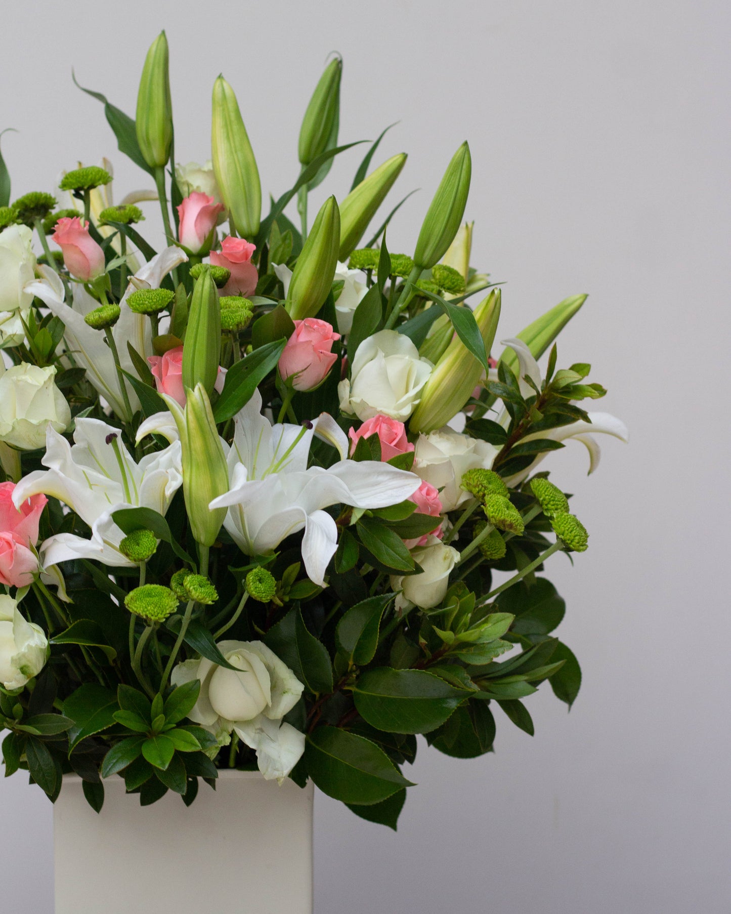 Premium flower delivery featuring an elegant white tin with White Oriental Lilies, soft Pink Roses, and fresh Green Chrysanthemum blooms. This big flower bouquet is perfect for same-day florist delivery, online flower delivery in Bangalore, and bouquet delivery near you. Ideal for special occasions like birthdays, anniversaries, and luxury flower gifting. Order now for home delivery flowers and the best bouquet flowers